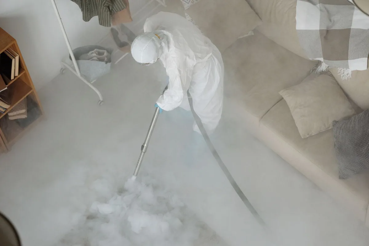Biohazard cleanup technician in protective equipment, Wapello, IA